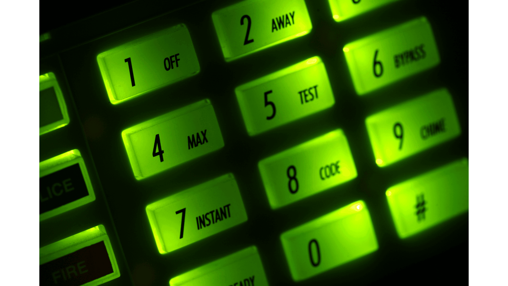 Close-up view of an illuminated keypad with green backlit buttons displaying various numbers and functions.