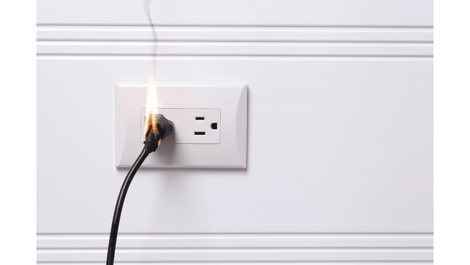 Electrical outlet with a plug catching fire, emitting smoke.