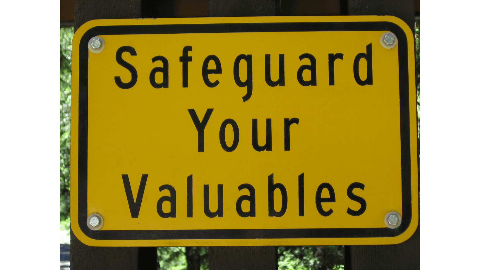 Yellow sign with the text 'Safeguard Your Valuables' in black letters.